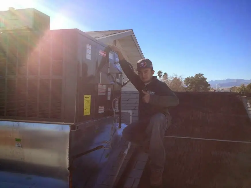 HVAC technician performing Boiler Repair on a rooftop unit in Sangaree